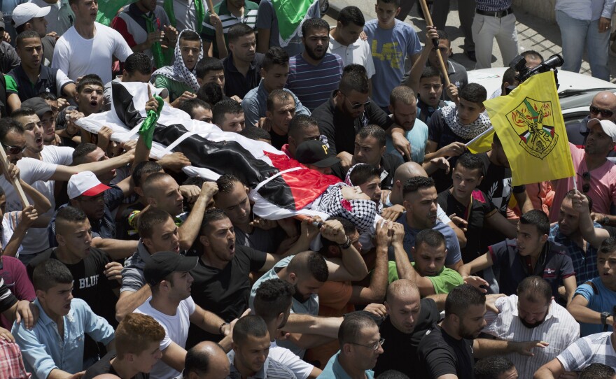 Mourners carry the body of Palestinian Laith al-Khaldi during his funeral procession at the Jalazoun refugee camp, near the West Bank city of Ramallah, on Aug. 1, 2015. An Israeli soldier shot Khaldi after he had been throwing rocks at a military post. This was during a relatively calm period, although almost two dozen Palestinians were killed during the first half of the year.