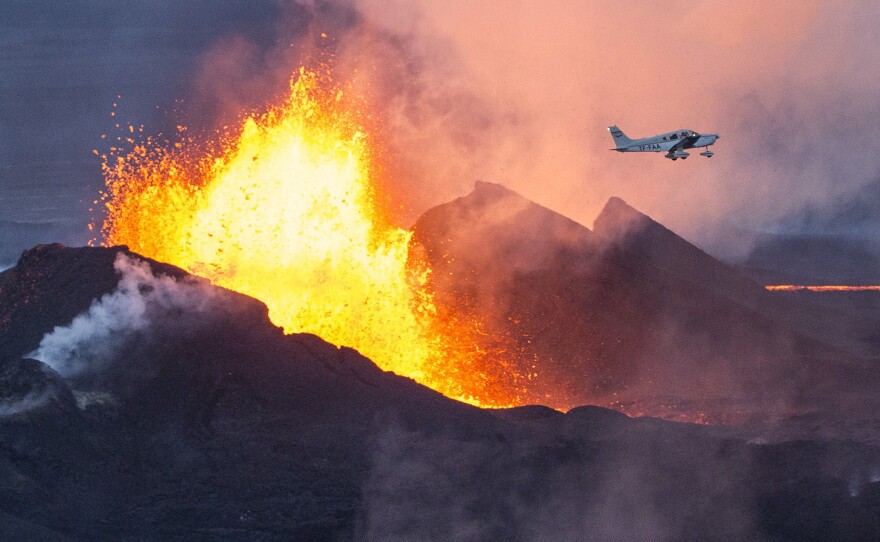 A plane flies over the Bardarbunga volcano as it spews lava and smoke in southeast Iceland on Sept. 14. The Bardarbunga volcano system has been rocked by hundreds of tremors a day since mid-August, prompting fears the volcano could explode.