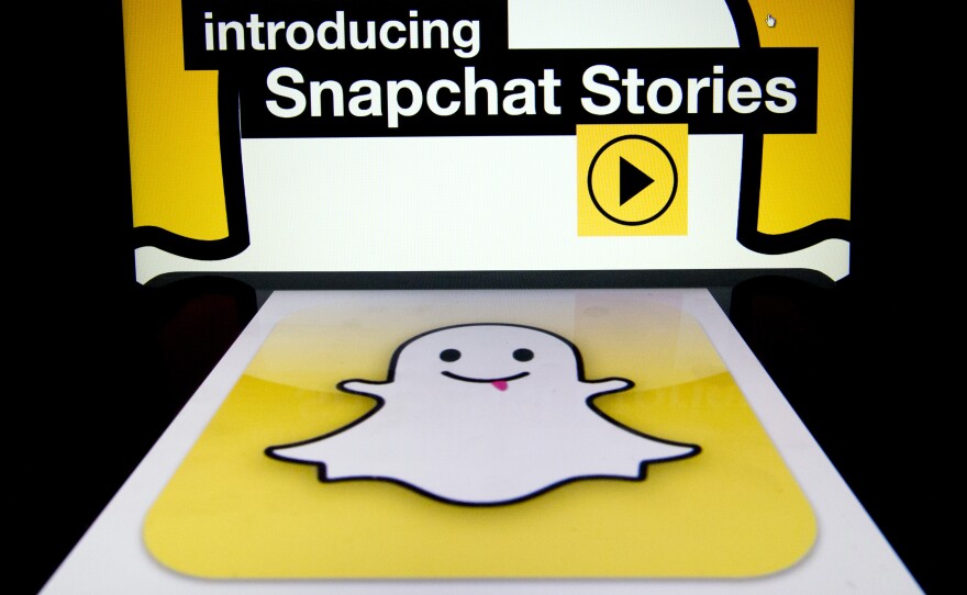 The logo and a page of mobile app "Snapchat" are displayed on tablets. Hackers broke into Snapchat, the popular mobile app, accessing the phone numbers and usernames of 4.6 million users and publishing them online.