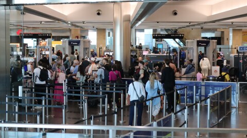 Passengers wait in the Terminal 2 security line at the San Diego International Airport on Monday, March 23, 2026.