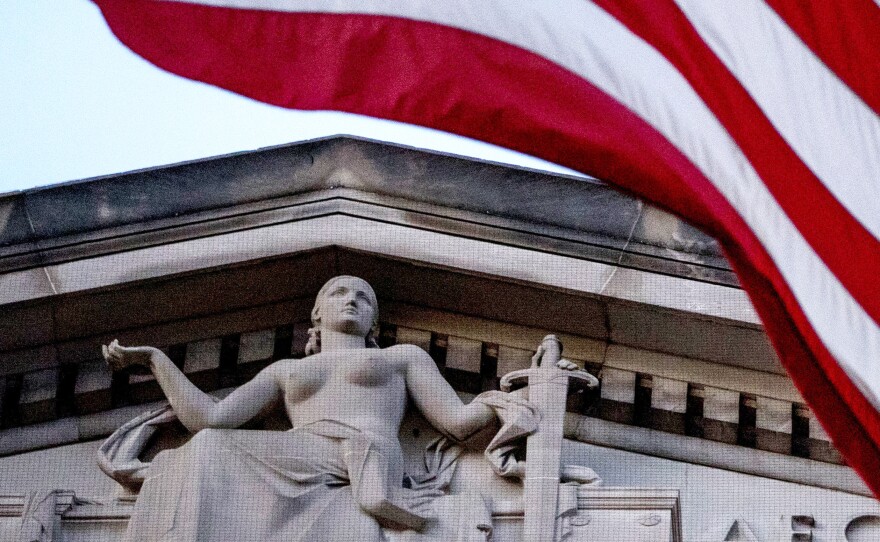 An American flag flies outside the Department of Justice in Washington in March 2019.