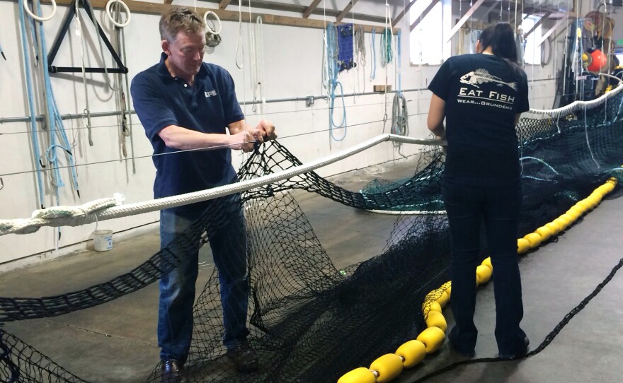 Rob Maxwell (left), and Casey Landaluce make fishing nets. Maxwell used to be a herring fisherman in Alaska.