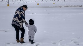 People walk in the snow at Golden Acorn Casino & Travel Center in Campo, Calif. Feb. 24, 2023.