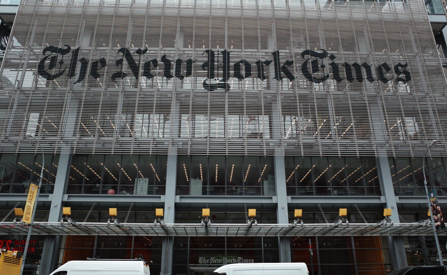 The New York Times says federal agents showed up at several of its journalists' homes Friday night to try to force them to testify before a grand jury next week.