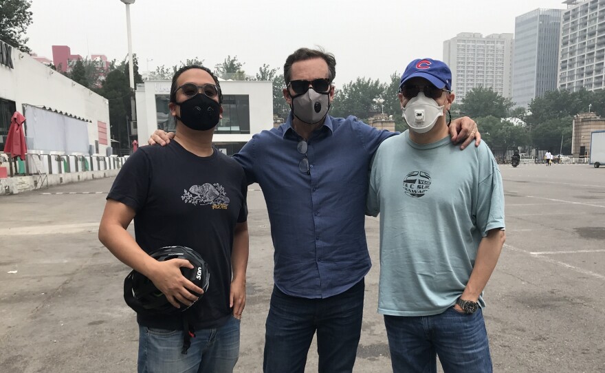 NPR's Anthony Kuhn (right), with Bob Woodruff (middle) and Karson Yiu (left), both of ABC News, at Beijing Workers' Stadium in May 2018.