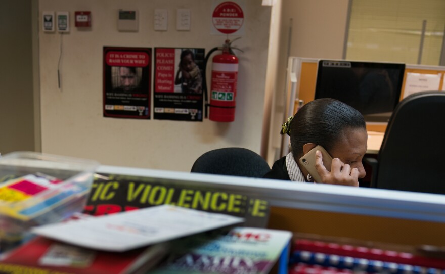 Aigio Ula, a case coordinator for the secretariat, takes a call in the office. The office connects survivors of gender-based violence with shelters, medical care and other services in Port Moresby.