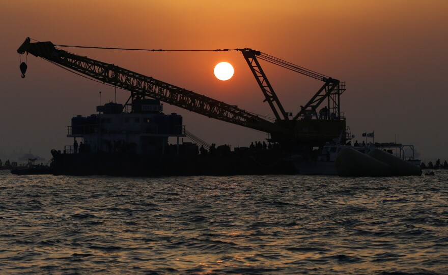 As the sun set on Tuesday, recovery operations continued at the site of the ferry disaster off South Korea's southern coast.