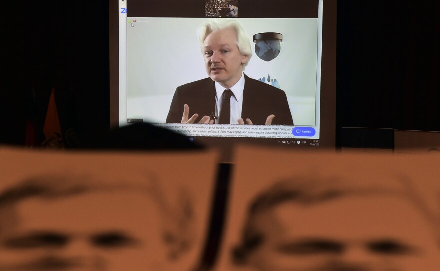 WikiLeaks founder Julian Assange appears via videoconference at an auditorium in Quito, Ecuador, on June 23.