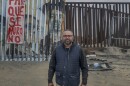 Mexican artist Enrique Chiu stands on the beach of the Mexican community of Playas de Tijuana, one section of the border wall behind him has been removed, Tijuana, August 21, 2023. Chiu began painting murals on the American-built border separating Tijuana and San Diego in 2016. With the construction of a new taller wall many sections of the current wall are being removed, and the murals Chiu and others created along with it.