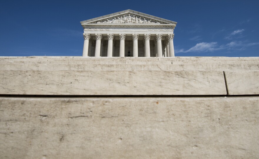 The Supreme Court has ruled previously that police cannot search the private area around a house without a warrant, but the question here was whether the warrant requirement applied to motor vehicles parked within that area.