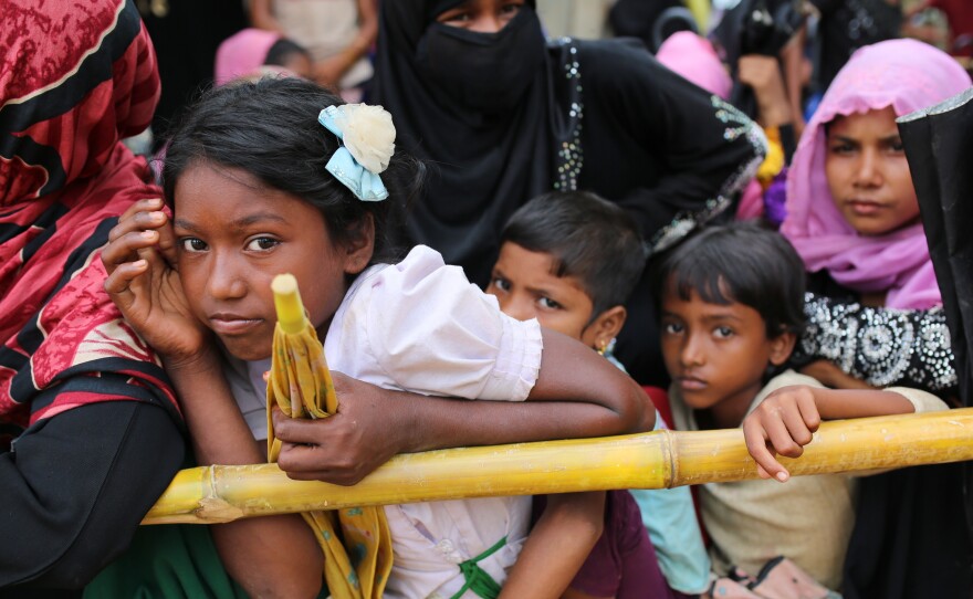 Rohingya children wait for food handouts at Thangkhali refugee camp in Cox's Bazar, Bangladesh, on Thursday.