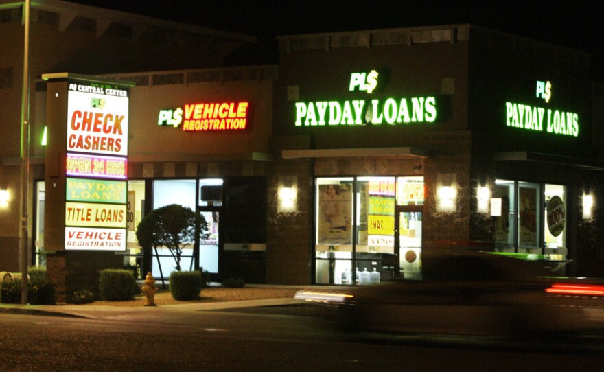 Neon signs illuminate a payday loan business in Phoenix.