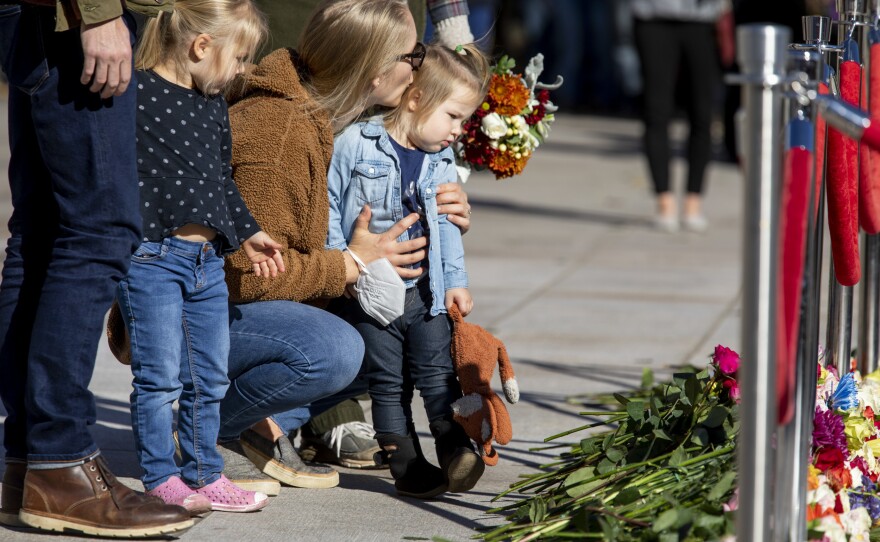 Stacy Wittmeyer kisses her daughter, Margaux Wittmeyer, 2, as her other daughter, Brynly Wittmeyer, 3, looks on after they and their family laid flowers at the Tomb of the Unknown Soldier during the centennial celebration.