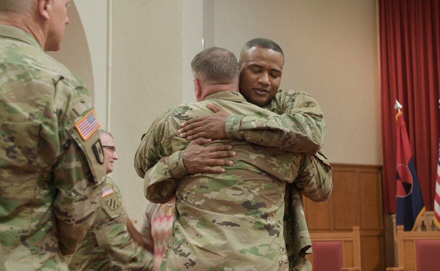 Khallid Shabazz hugs soldier at Joint Base Lewis-McChord, Washington