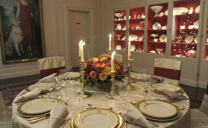 The Truman china set is displayed on a table in the White House's China Room. This set, selected by first lady Bess Truman in 1951, is the first state china service to feature the presidential coat of arms as redesigned by President Harry Truman in 1945.