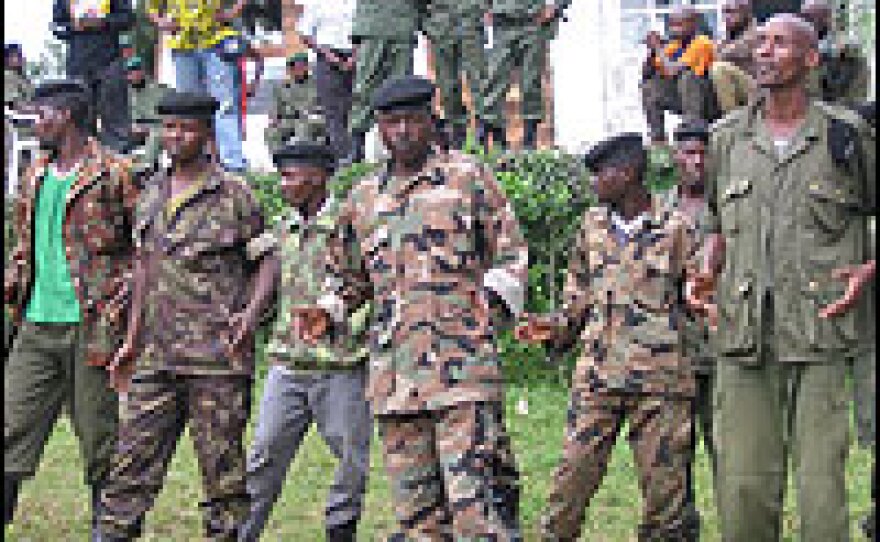Ex-rebel fighters, including Theoneste Bugarade (far right), sing a song, urging rebel general Laurent Nkunda to join forces with the government soldiers loyal to the Congolese leader. Bugarade used to be a part of the rebel army but left after he thought he was being deceived by them.