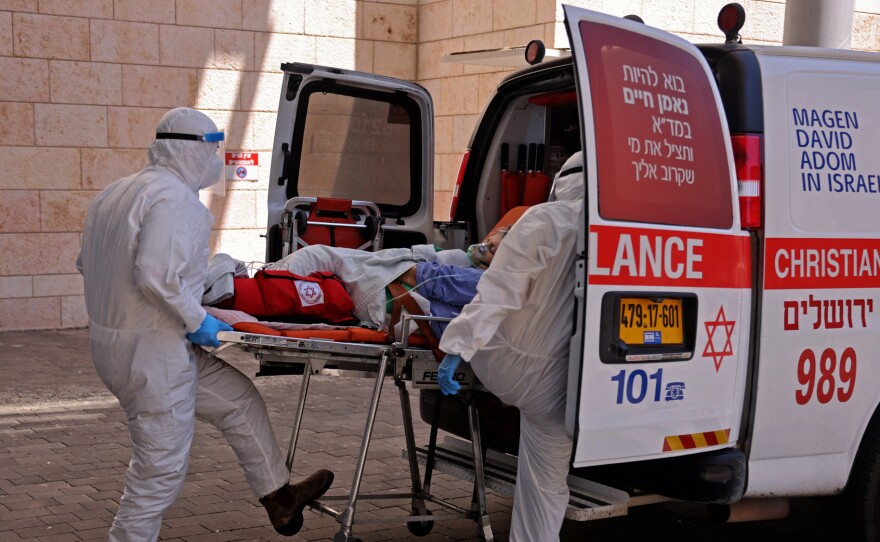 Medics in Jerusalem transfer a COVID-19 patient to the Hadassah Ein Kerem Hospital. Many hospitals in Israel are at full capacity following a sharp increase in the number of coronavirus infections.