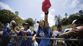 A San Diego Chargers fan waits for autographs during the Chargers NFL football minicamp in San Diego, June 14, 2016.
