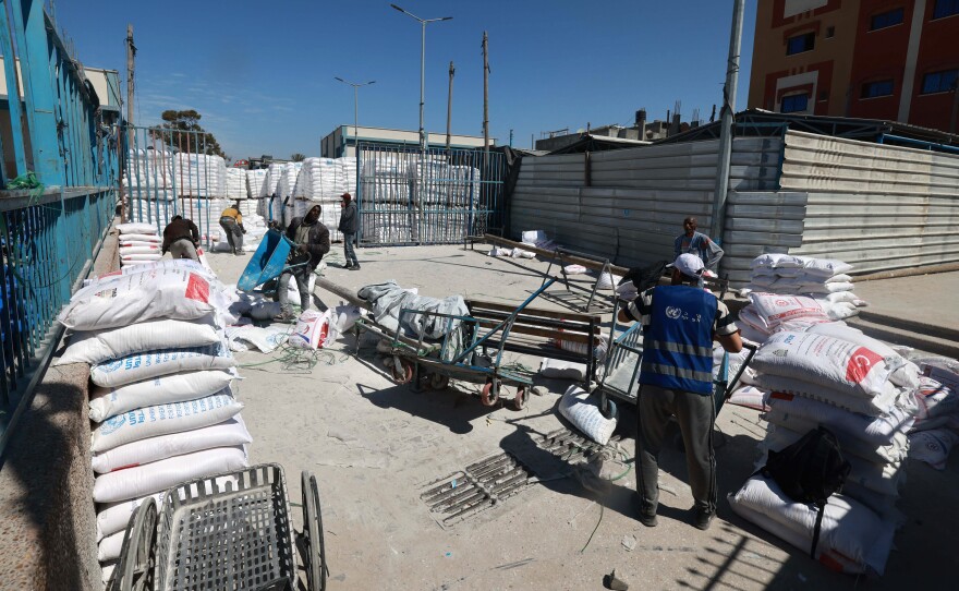 UN workers are pictured at a UNRWA warehouse/distribution centre in Rafah, in the southern Gaza Strip, which was partially hit by an strike on March 13, 2024, amid continuing battles between Israel and the Palestinian militant group Hamas.