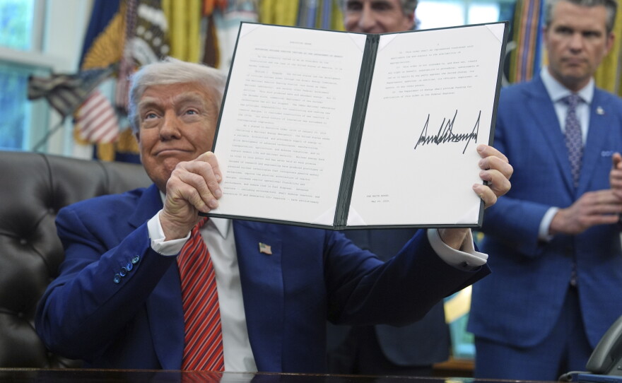President Trump displays an executive order regarding nuclear reactor testing in the Oval Office of the White House on May 23, 2025. The executive order stipulates that the president hopes to see reactors online by July 4 of this year.