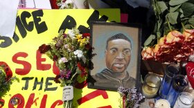 A chain portrait of George Floyd is part of the memorial for him, Wednesday, May 27, 2020, near the site of the arrest of Floyd who died in police custody.