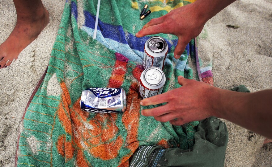 A college student reaches for a beer during spring break in Miami.