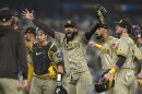 San Diego Padres' Fernando Tatis Jr., center, celebrates with teammates after the Padres clinched a playoff spot with a triple play to end their baseball game against the Los Angeles Dodgers, Tuesday, Sept. 24, 2024, in Los Angeles.