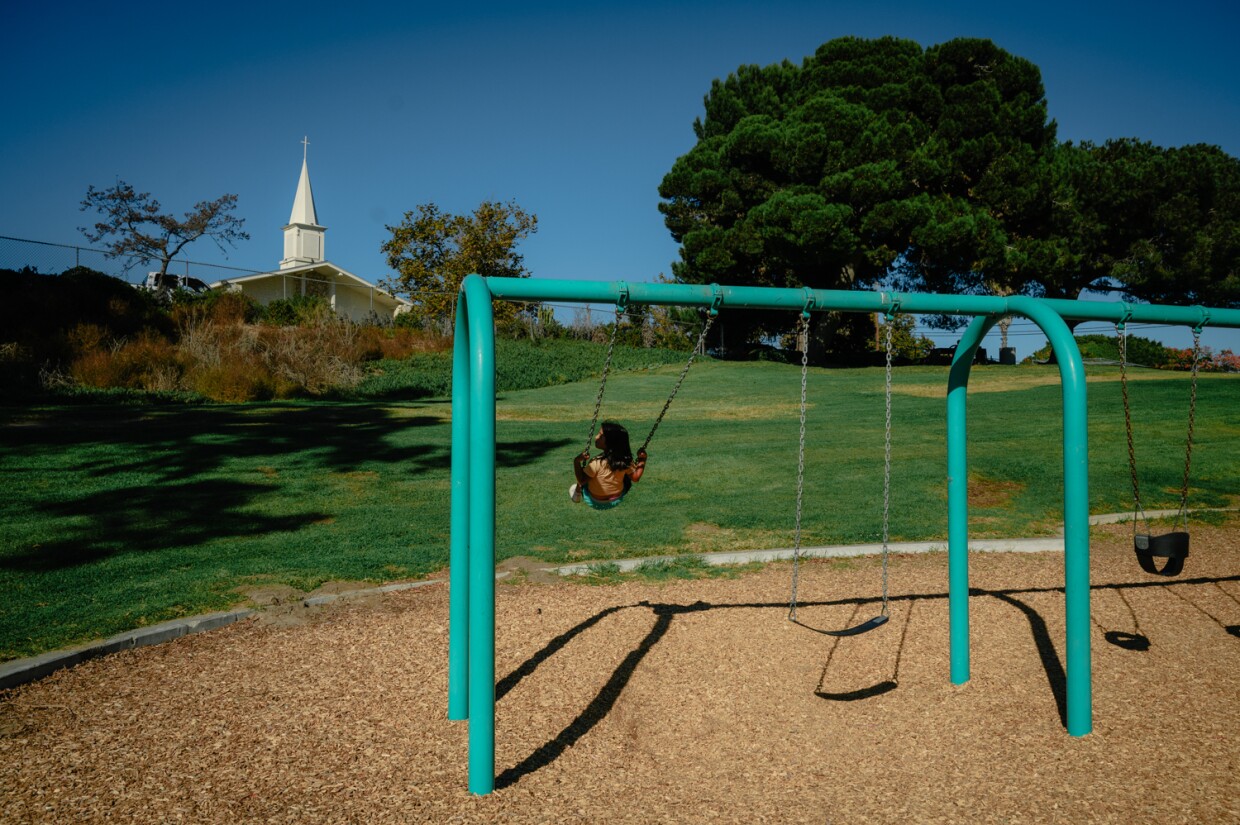 Valentina, 8, plays on the swings at Hilltop Park in West Chula Vista on Oct. 31, 2023. The ongoing closure of Harborside Park has drawn renewed attention to the unequal way that Chula Vista’s parks are distributed across the city.