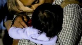 Lance Cpl. Ernesto Menjivar hugs his wife, Ashley, and daughter, Lucy, before leaving on deployment Sept. 14, 2013.



