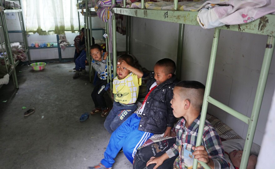 Ethnic Yi schoolboys settle into their dorm rooms on the first day of a new semester at the Le'er primary school.