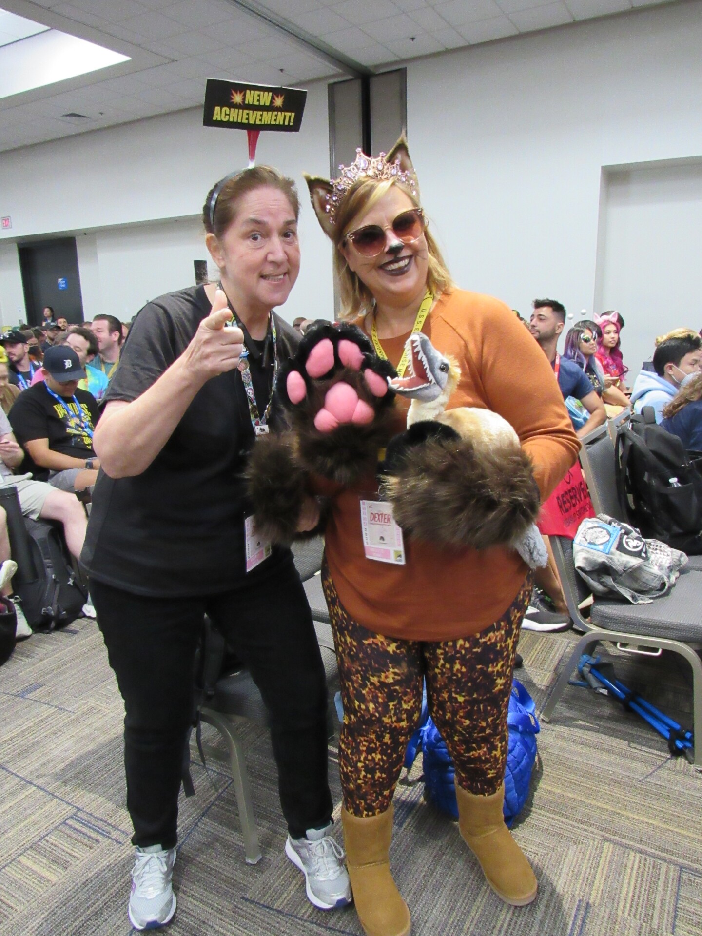 Fans of Matt Dinniman's "Dungeon Crawler Carl" cosplay as the "AI" system (left) and Princess Donut (right) on July 26, 2025.