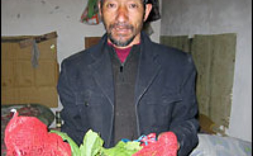 Dong Xuelu from central Hubei province collects wilted cabbage leaves that have been discarded by vendors at a nearby vegetable market.