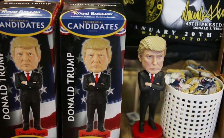 Donald Trump bobble head dolls for sale on a shelf at White House Gifts. The influx of visitors to D.C. for the inauguration may create security headaches, but means big business for the local economy.