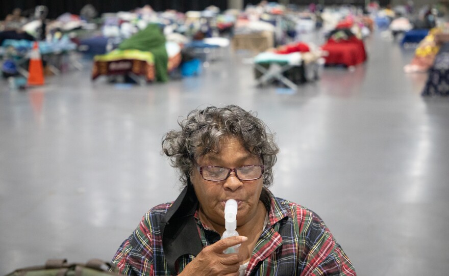 Deborah Jackson, who’s been homeless for five years, uses a nebulizer to take albuterol for her asthma and COPD, May 21, 2020. Jackson has been staying in the Alpha Project section of the San Diego Convention Center since late April.