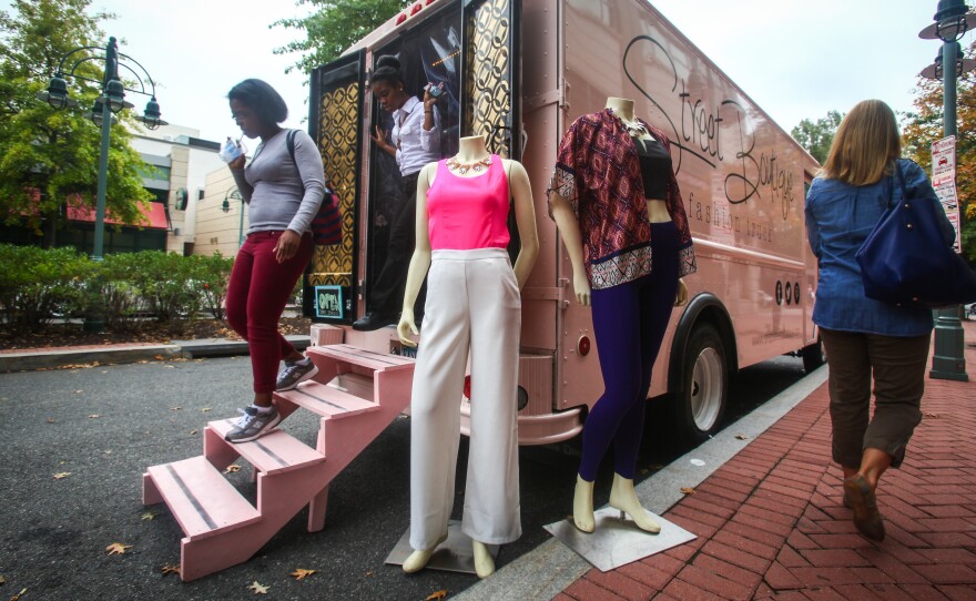 Customers walk out of Street Boutique, parked in Shirlington Village, Va. Street Boutique is a pop-up truck that's similar to the many food trucks in the area, except it sells clothes and jewelry.