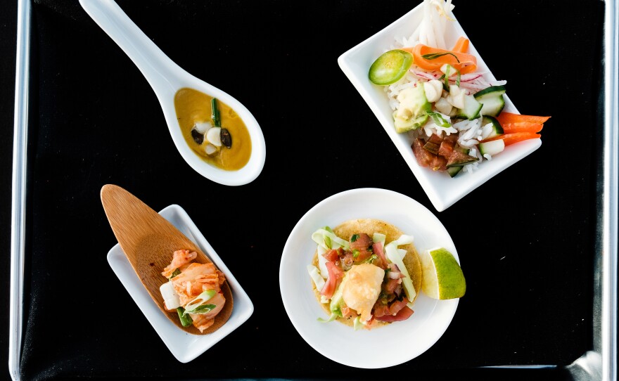 BlueNalu's whole-muscle, cell-based yellowtail prepared in four different recipes (clockwise from top left): roasted butternut squash & yellowtail bisque, poke bowl, fish taco, and kimchi, in an undated photo.