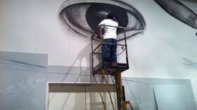 Artist Izze working on a small portion of the 70 foot mural at the San Diego Museum of Art.
