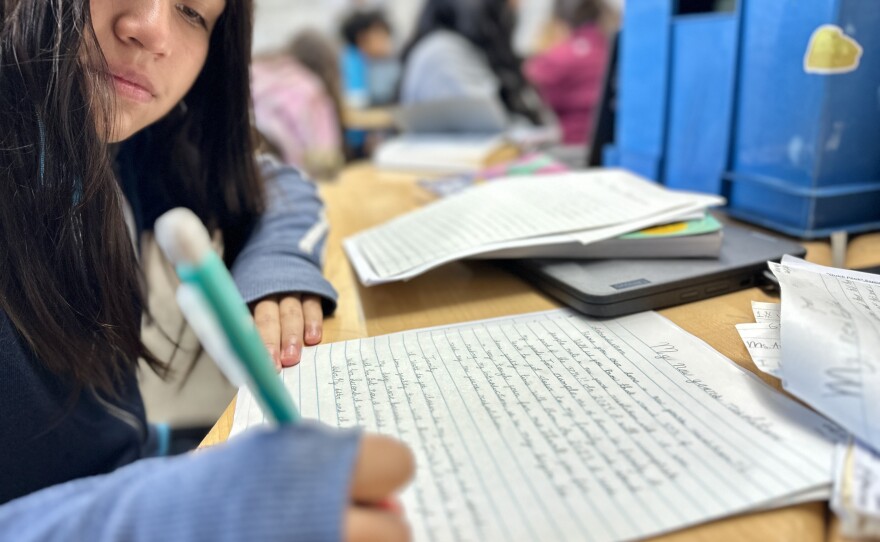 Sofia Cach, 11, uses cursive writing in preparing an essay about New Year's resolutions for her language arts class at Millennial Tech Middle School, San Diego, Calif., January 10, 2024