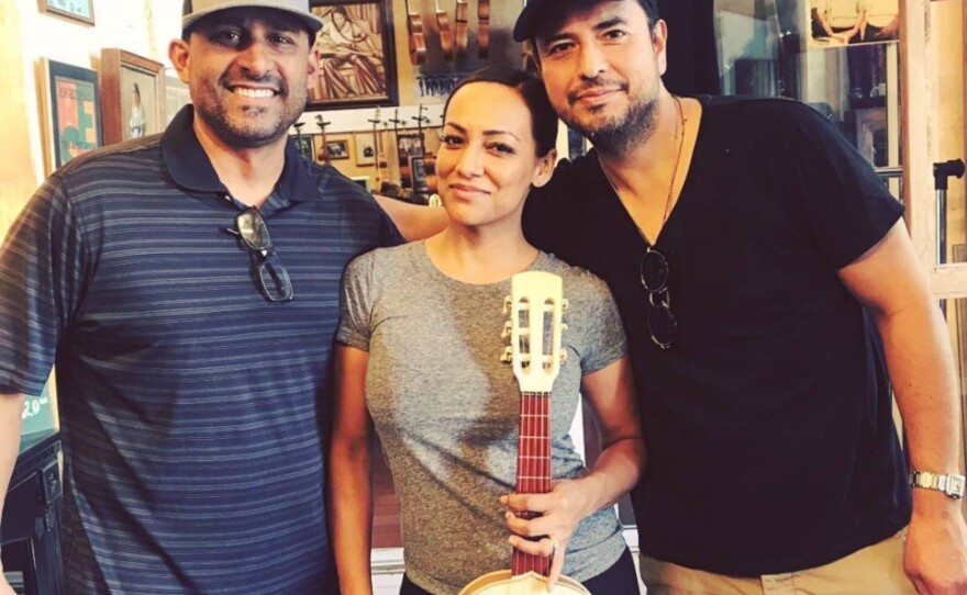 From right to left: Candelas Guitars owner Tomás Delgado, musician and customer Stephanie Amaro and her husband, guitarist Andy Abad.