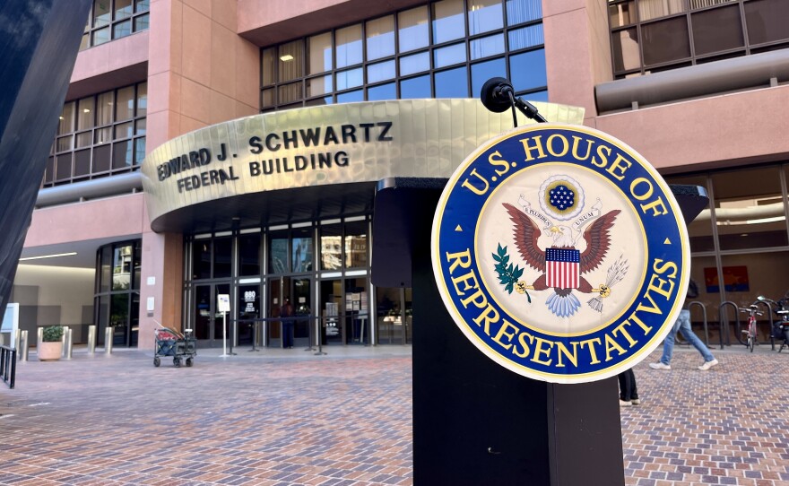 A podium for with a U.S. House of Representatives emblem stands in front of the Edward J. Schwartz Federal Building in downtown San Diego, Oct. 20, 2025.