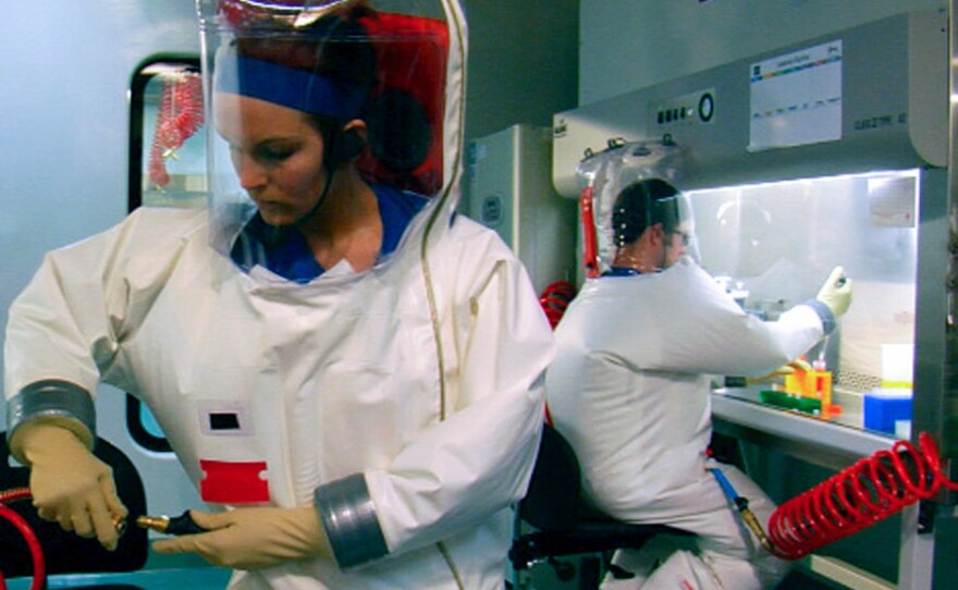 Two scientists are suited up for work inside the Biosafety Level 4 lab in Montana.