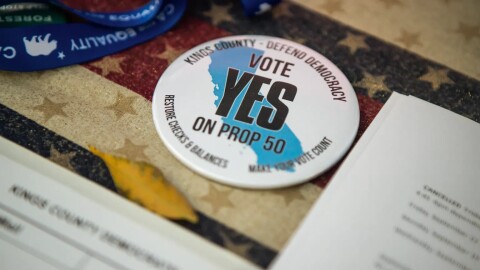 A button reads, “Vote Yes on Prop 50” at the Kings County Democrats booth during the Thursday Night Marketplace in downtown Hanford on Sept. 25, 2025. 
