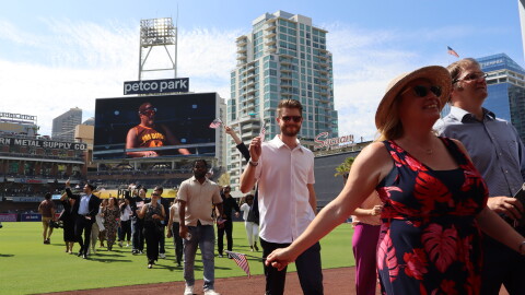 New U.S. citizens walk off the Petco Park field after taking the Oath of Allegiance in a naturalization ceremony on Wednesday, Aug. 21, 2024.