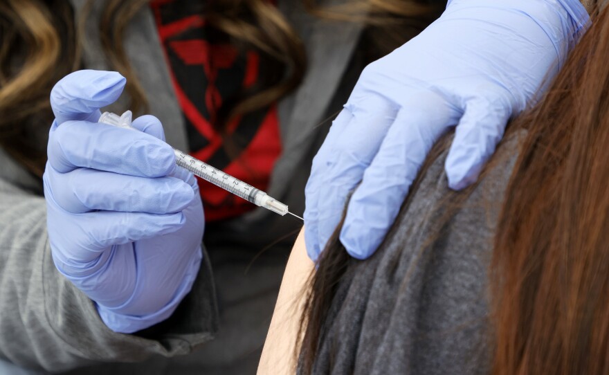 A woman receives a booster shot at a pop-up vaccination clinic in Las Vegas on Dec. 21.