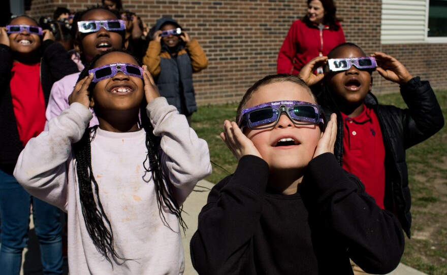 Second graders practice using solar eclipse glasses outside Winchester Village Elementary School in Indianapolis.