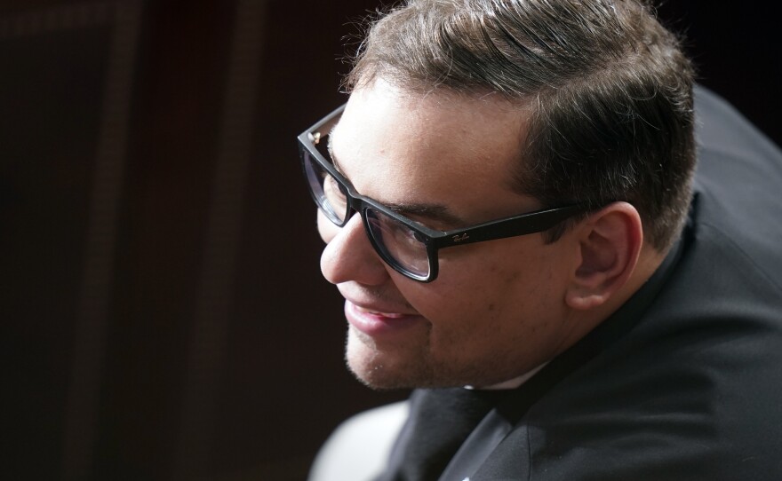 Rep. George Santos, R-N.Y., is shown listening as Republicans try to elect Rep. Mike Johnson, R-La., to be the new House speaker, at the Capitol in Washington, Wednesday, Oct. 25, 2023.