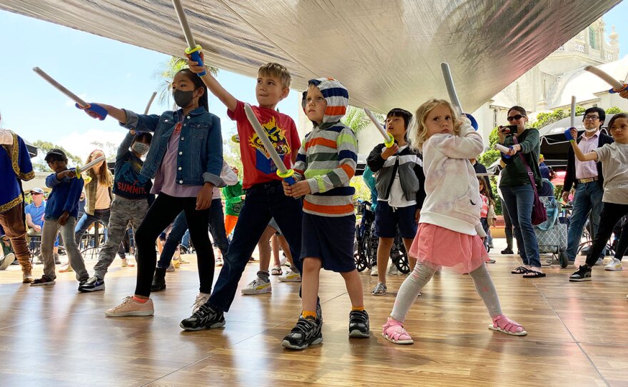 Children participate in a theatrical sword fighting workshop at the 2022 "Happy Birthday Mr. Shakespeare" event at The Old Globe.