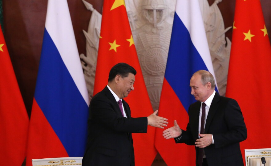 Chinese President Xi Jinping and Russian President Vladimir Putin shake hands during their meeting at the Grand Kremlin Palace on Wednesday in Moscow in June 2019.