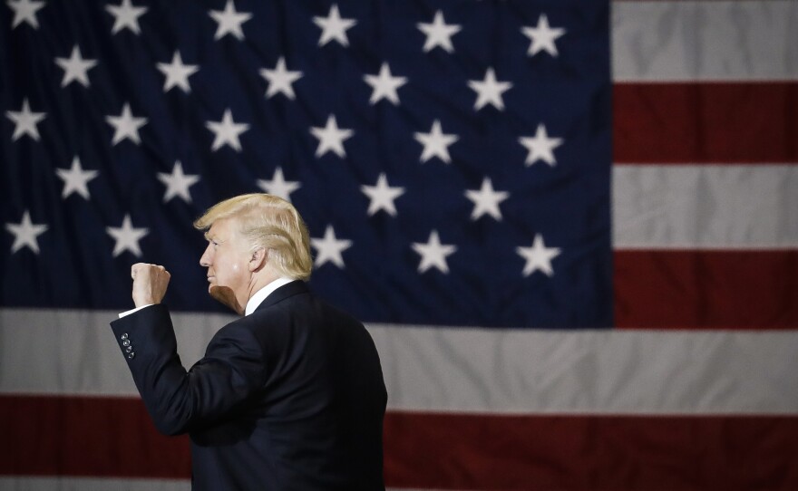 President Trump raises his fist as he leaves after speaking at a rally in Kentucky in March.