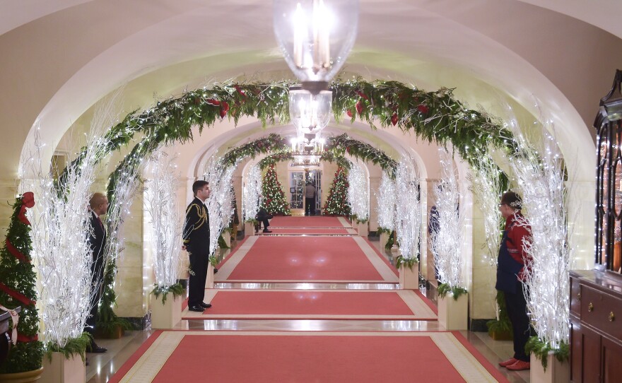 Holiday lights trace a hallway in the White House.